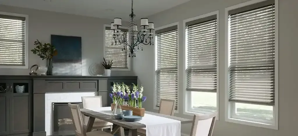 Dining room with wood blinds on the windows