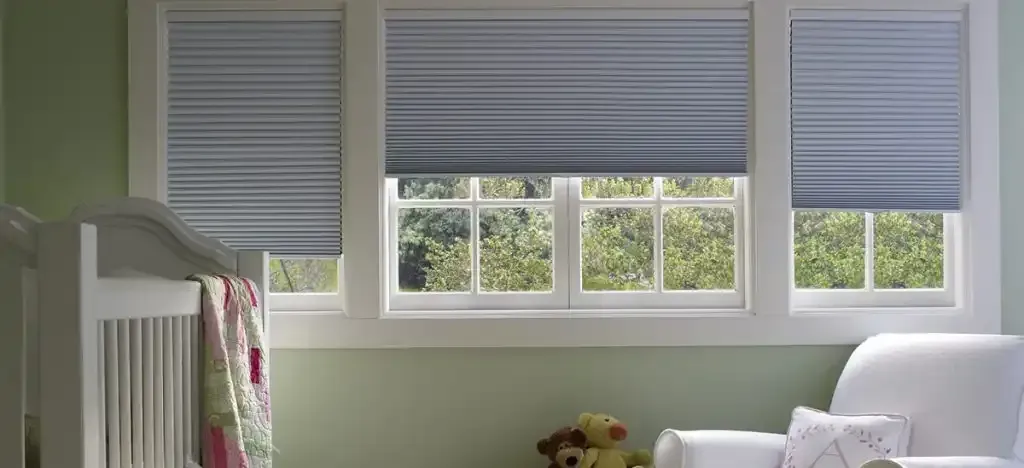 Nursery with light blue pleated blinds