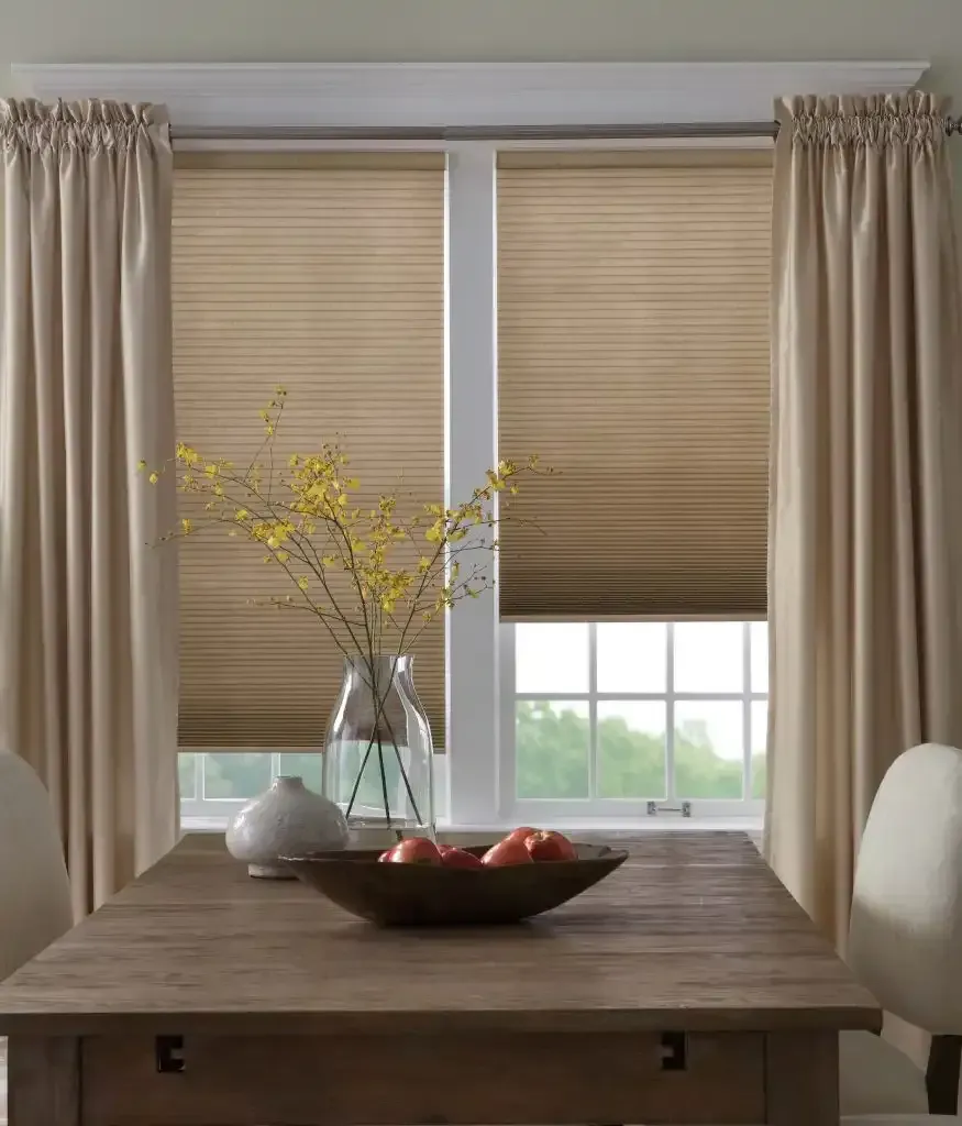 Dining room window with beige curtains and blinds