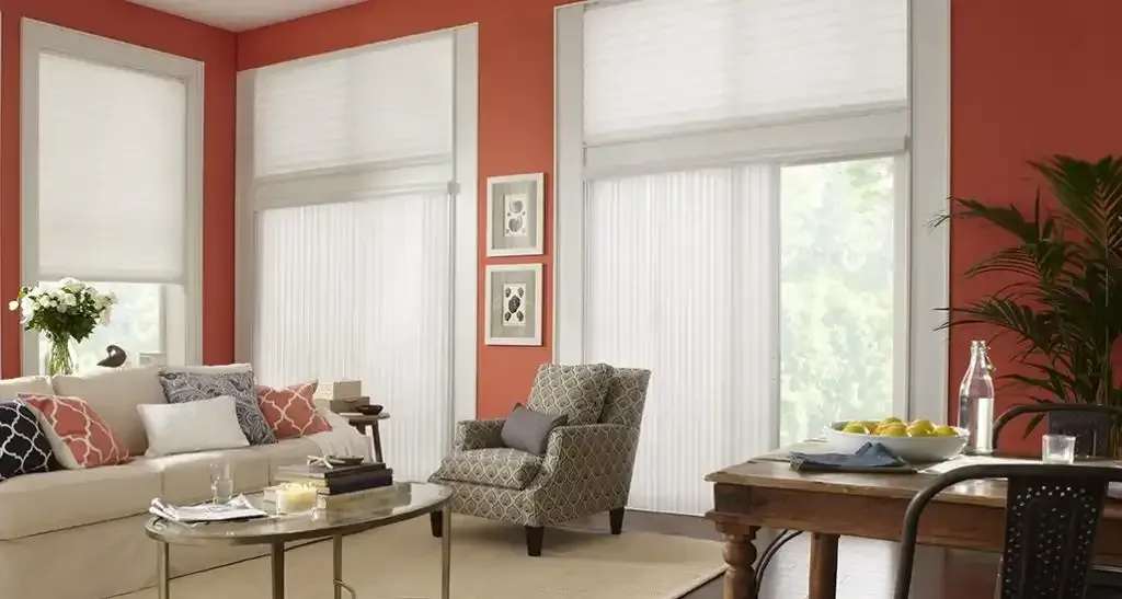 Living room with white vertical blinds and coral walls